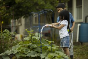 Wildlife Gardening For Kids-a-girl-and-boy-watering-plants